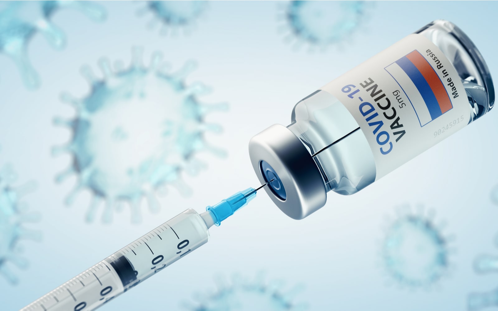 A bottle of COVID Vaccine and a Needle